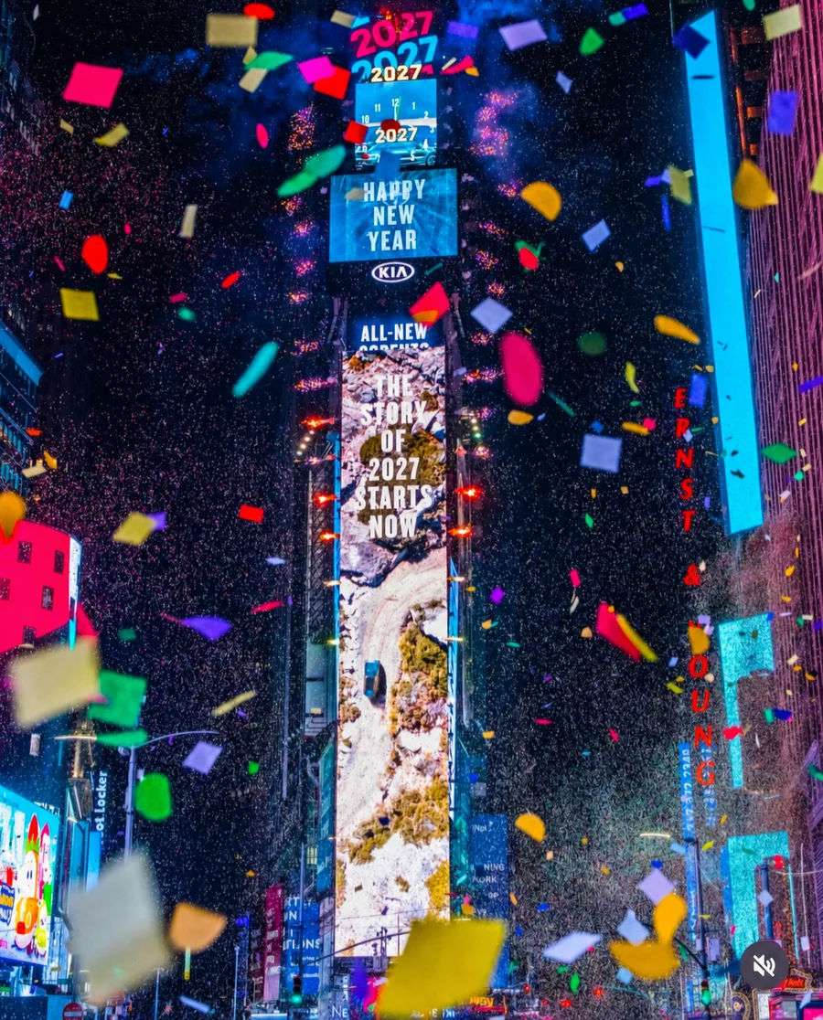 Times Square New Year's Eve ball drop with confetti over Manhattan